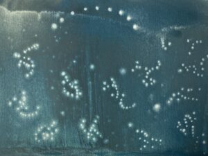 Little dots showing arc and rythmic elements interacting with eachother , green background with white dots in gouache color